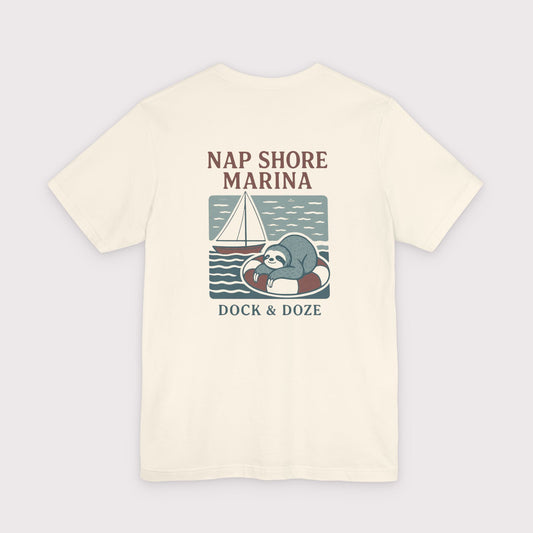 Beige t-shirt with a sloth graphic and text on a light gray background