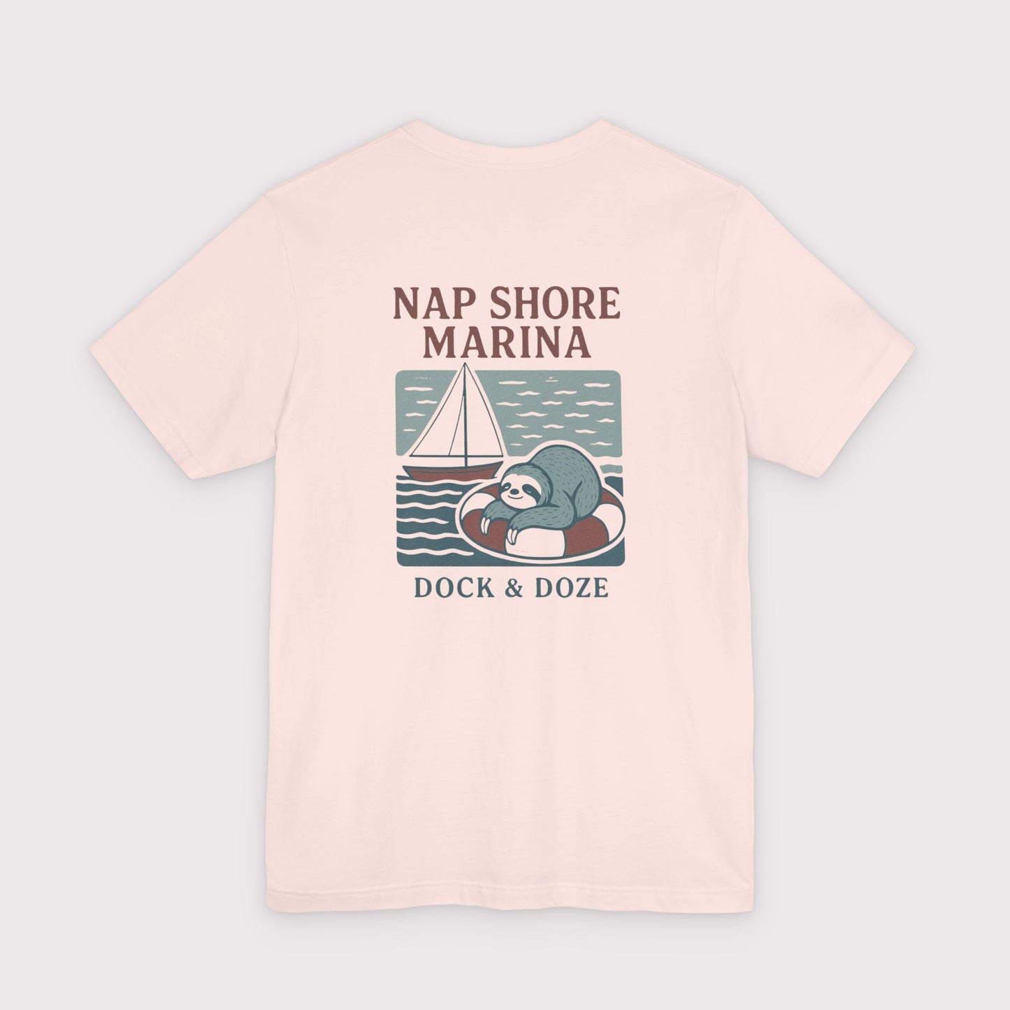 Pink t-shirt with a sloth graphic and text on a light gray background