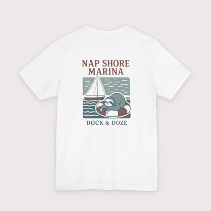 White t-shirt with a sloth graphic and text 'Nap Shore Marina' on a light gray background