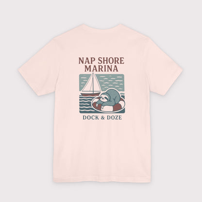 Pink t-shirt with a sloth graphic and text on a light gray background